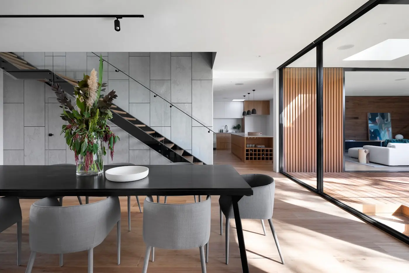 Dining area with a glazed partition and timber finishes