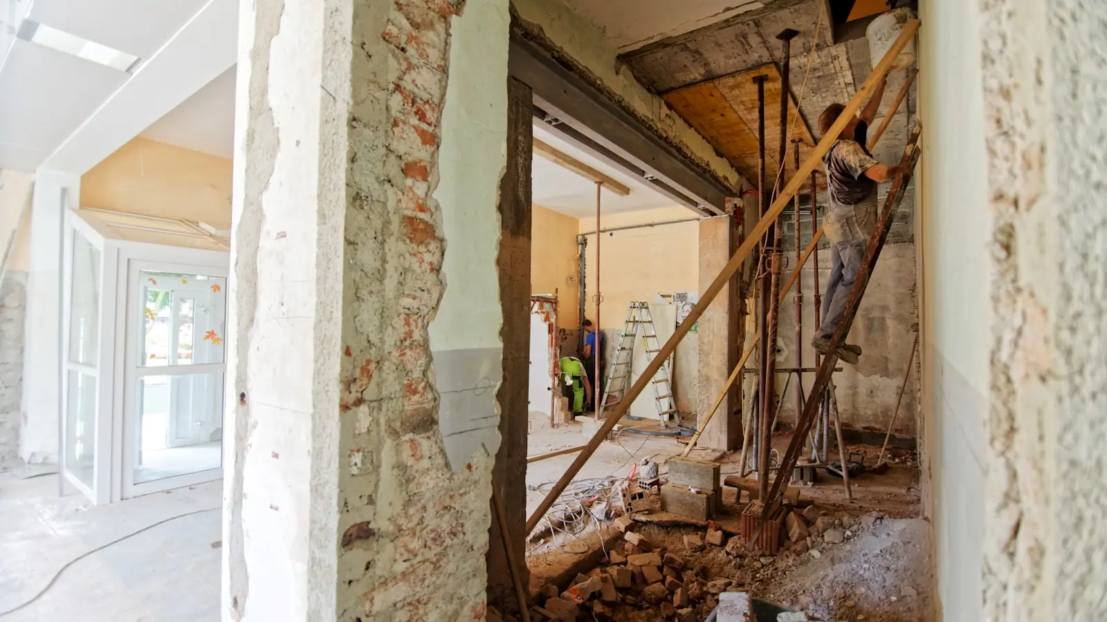 A room stripped back to brickwork and timber props during a refurbishment